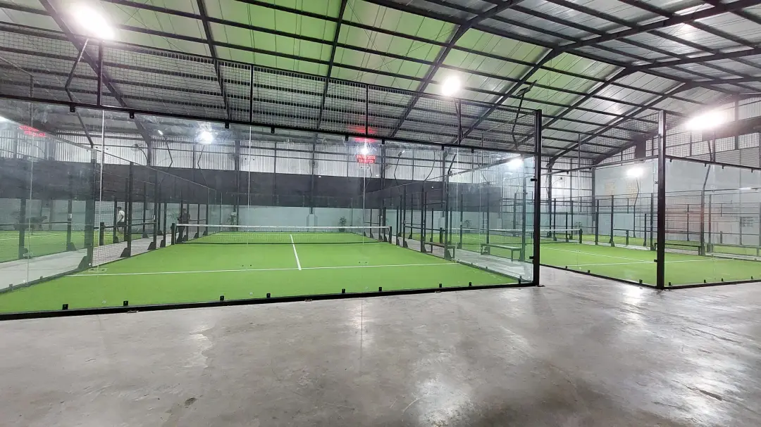 Rows of green courts under the steel roof