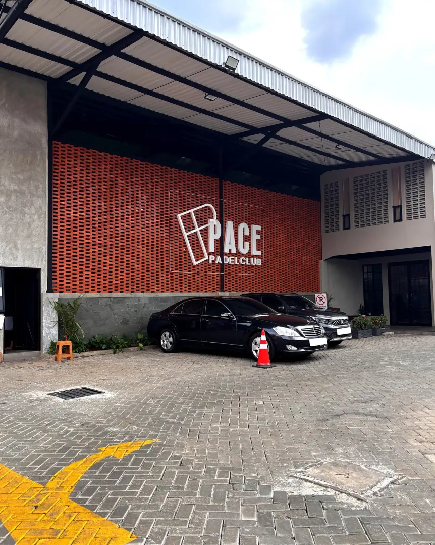 Brick facade with Pace logo and parking