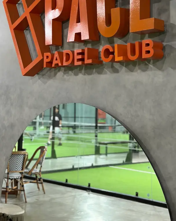 Orange Pace logo above an arched window to the courts