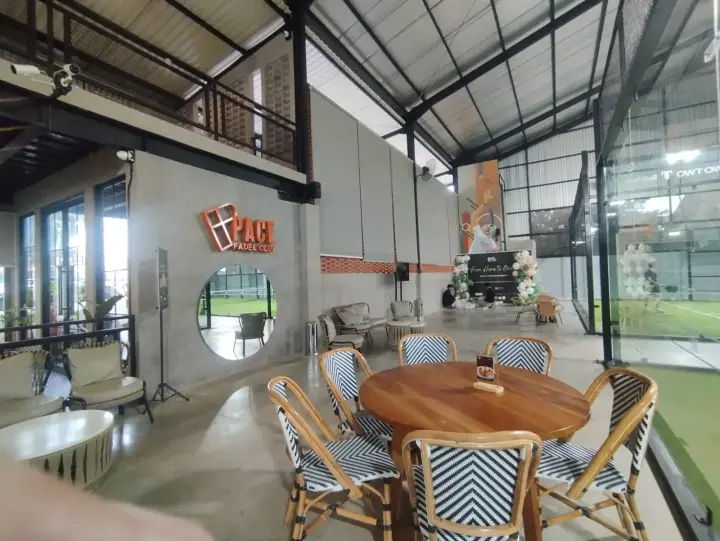 Lounge with rattan chairs and the Pace logo