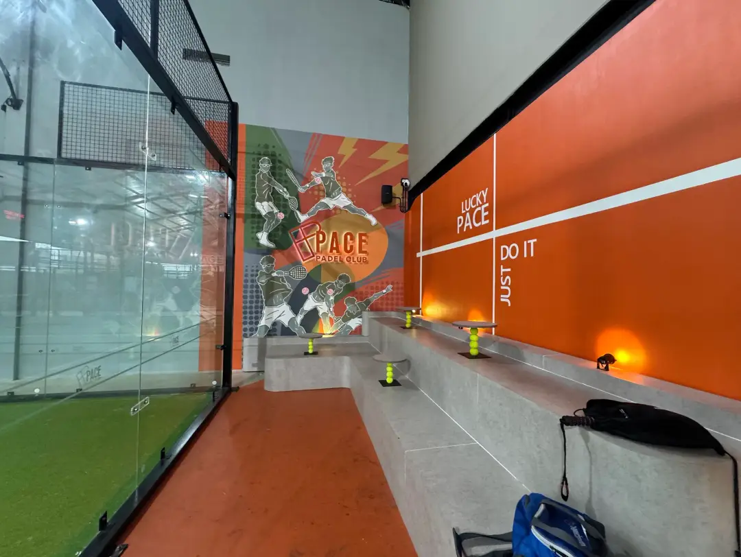Orange Lucky Pace wall beside a court